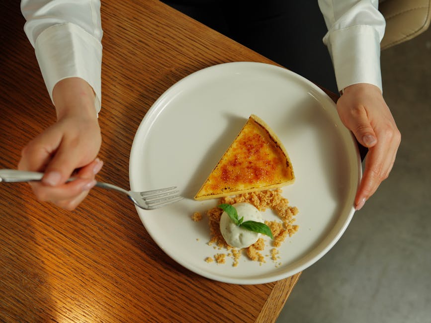 Elegant presentation of crème brûlée tart with ice cream on a plate.
